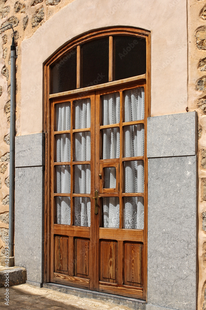 glazed wooden door in stone wall, mediterranean style glazed wooden door in stone wall, mediterranean style