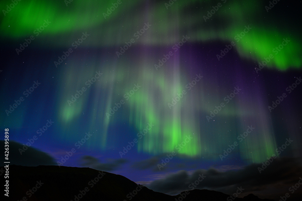 The dancing northern lights of the Aurora Borealis above Landmannalaugar, Fjallabak Nature Reserve, Iceland
