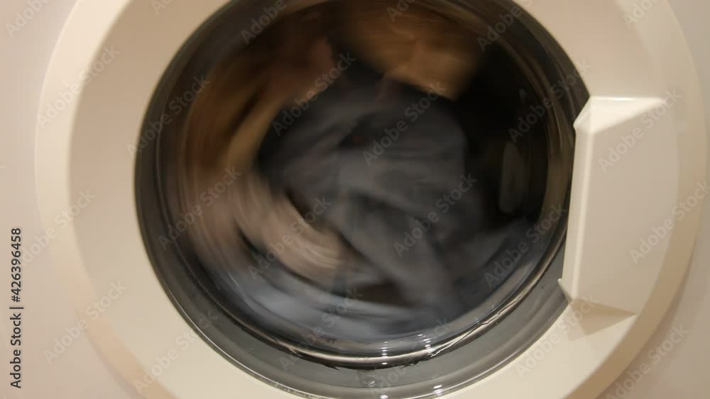 A clothing mix drying in front loaded wash machine can closeup, household washing A clothing mix drying in front loaded wash machine can closeup, household washing