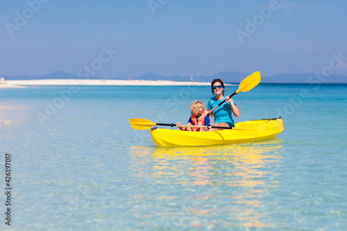 Kids kayaking in ocean. Family in kayak in tropical sea