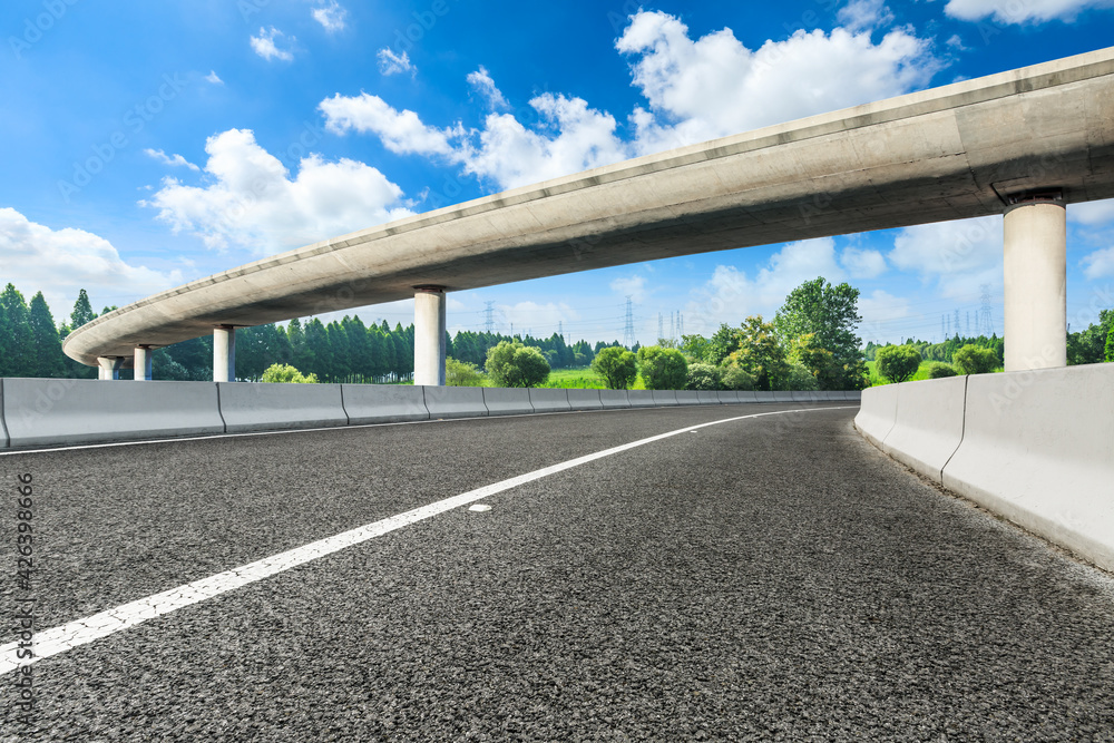 Asphalt road and green forest in spring season. Asphalt road and green forest in spring season.
