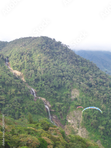 view with mountains waterfall and paraseling photo