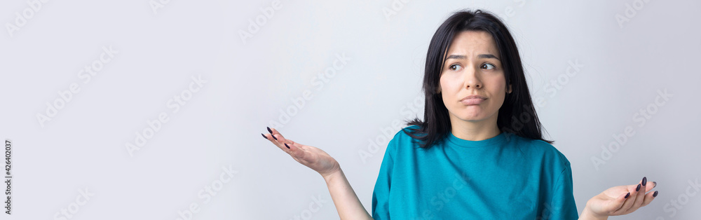 I don't know. Studio shot of confused brunette female. I don't know. Studio shot of confused brunette female.