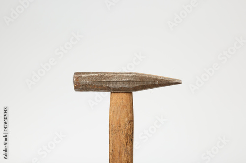 Hammer with a wooden handle. An old and worn hammer. Metal hammer with wooden handle isolated on white background. Hammer.  photo