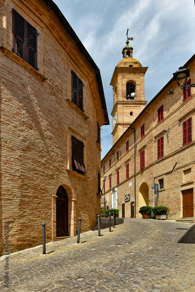 A narrow street between the old houses of Montecosaro, a medieval town in the Marche region of Italy.