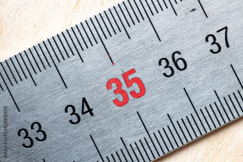 Figures on a metal line on a wooden background