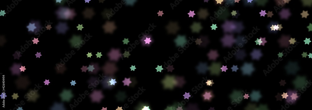 Star shaped bokeh image with black background.