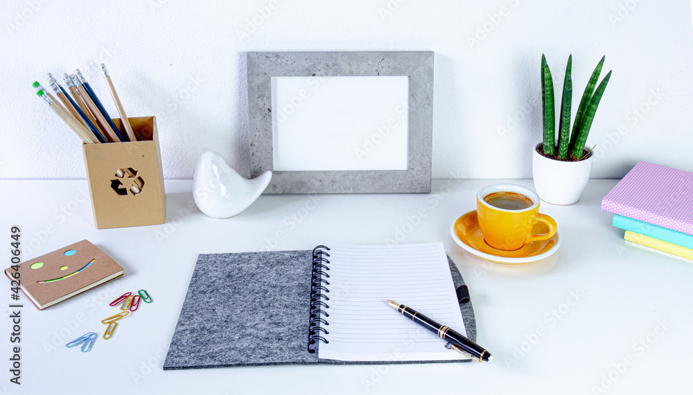 Workspace home office. Cozy home office on white table , fountain pen,  yellow cup of coffee, frame with space for tekst, notebook Background with copy space. Elegant feminine workspace. - obrazy, fototapety, plakaty 