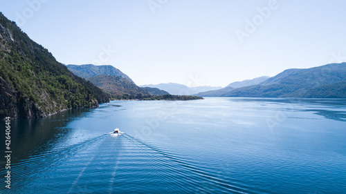 Catamarán Vittoria, recorriendo el lago Lacar, desde San Martin de los Andes hasta la playa Quila Quina. Patagonia, Argentina. Ruta de los 7 lagos. Lago de deshielo ubicado entre las montañas  photo