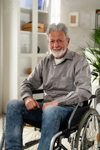 Disabled senior man in wheelchair. Smiling old man in wheelchair..