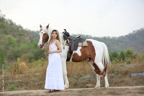 Women on skirt dress Riding Horses On field landscape Against Sky During Sunset