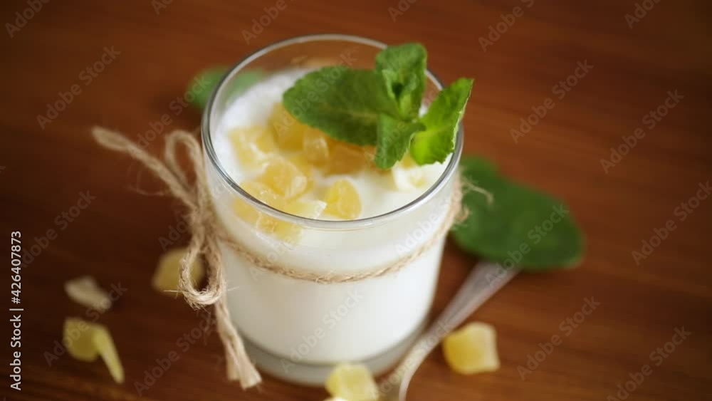 Sweet homemade yogurt with candied fruits in a glass Sweet homemade yogurt with candied fruits in a glass