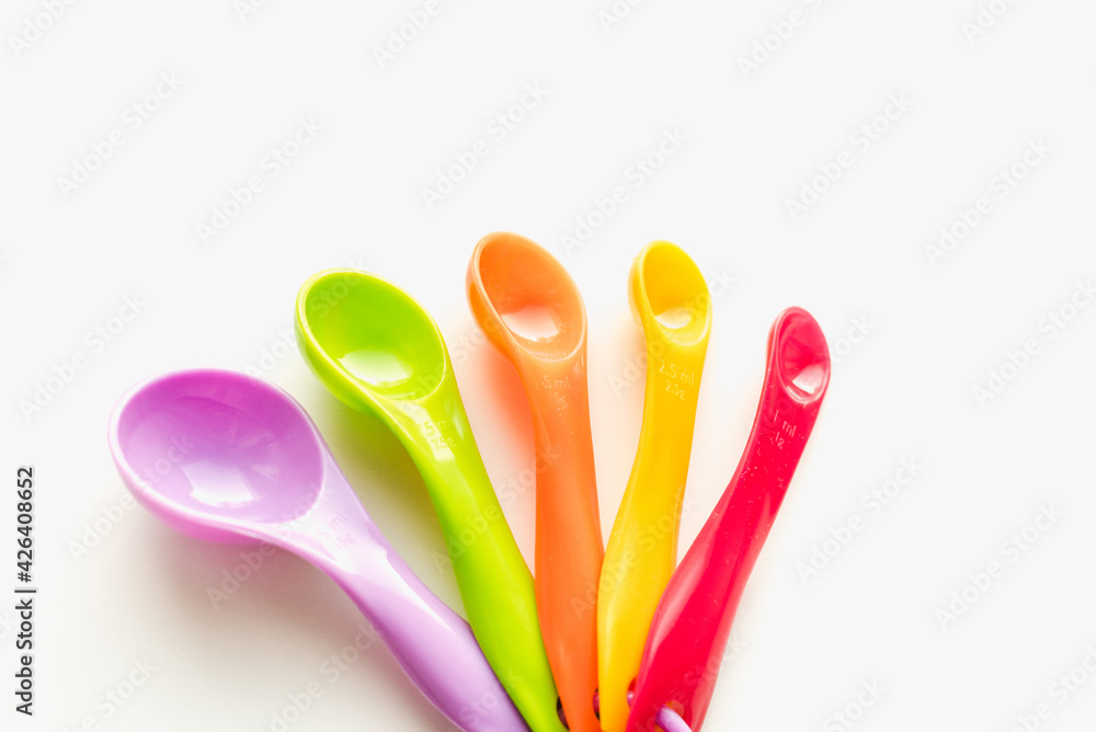 colored measuring spoons on white background, measuring spoons on white background colored measuring spoons on white background, measuring spoons on white background