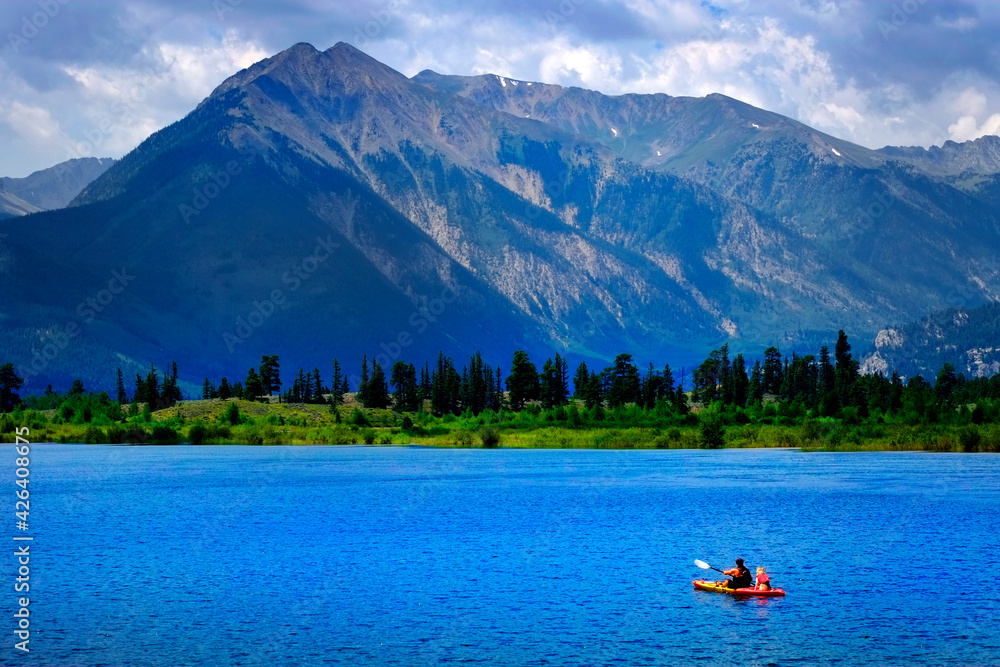 Fototapeta Man on Kayak on Lake Mountains Wilderness Paddling