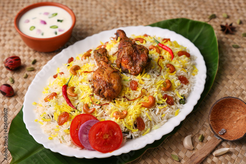 Chicken biryani Spicy Indian Malabar biryani Hyderabadi biryani, Dum Biriyani pulao golden bowl Kerala India Sri Lanka Pakistan basmati rice mixed rice dish with meat curry Ramadan Kareem, Eid