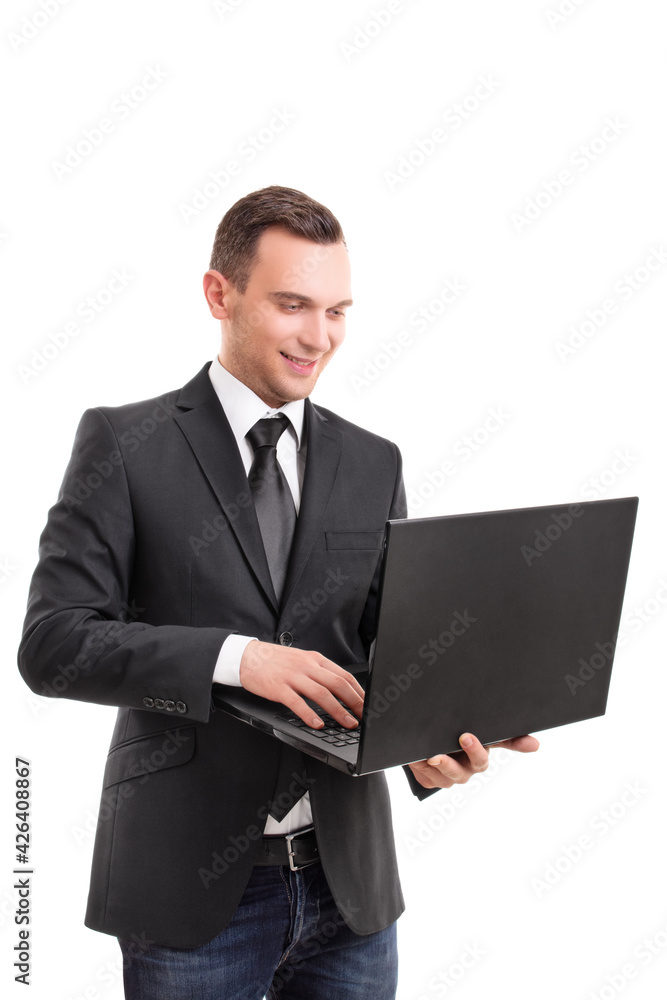 Attractive businessman holding a laptop and smiling Attractive businessman holding a laptop and smiling