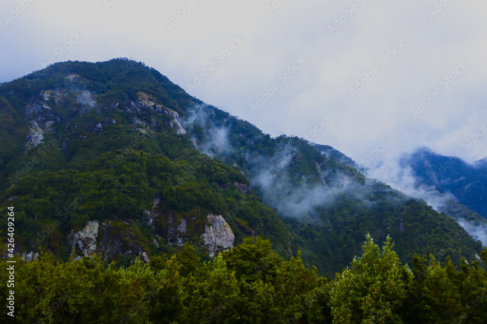 Panorama landscape of rainforest with mountains and fog. Chilean Patagonia.