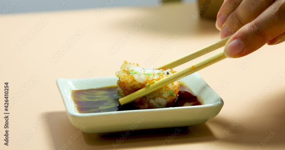 Sushi dipping in soy sauce Stock Video | Adobe Stock