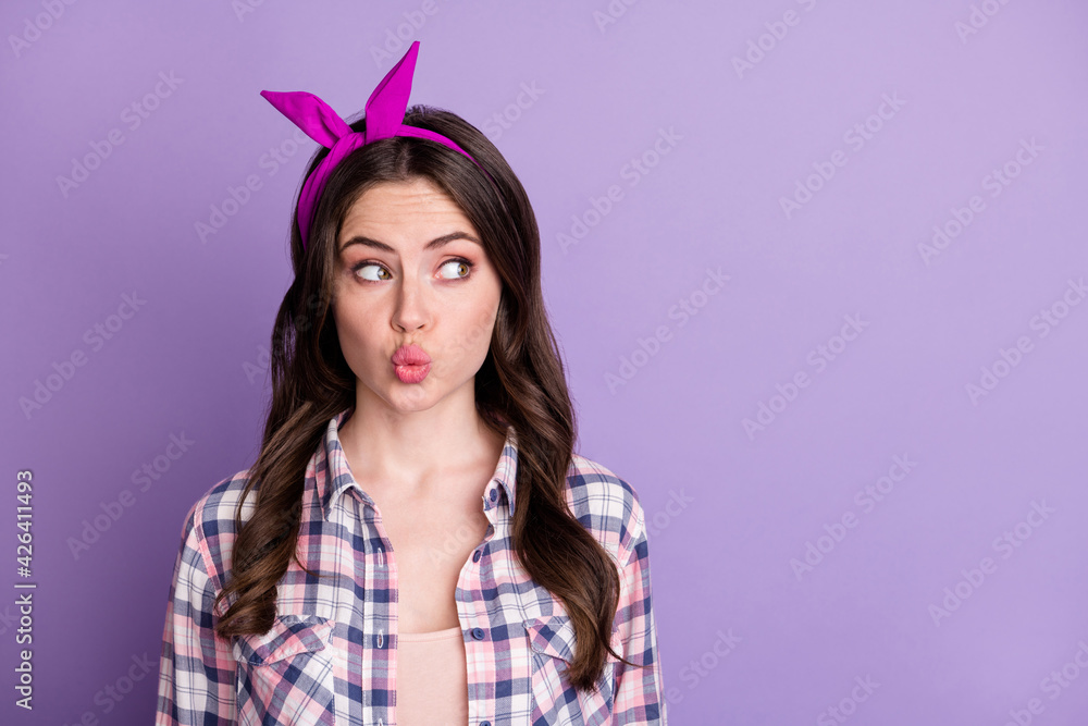 Photo portrait of lovely girl pouting looking at blank space isolated on vivid purple colored background Photo portrait of lovely girl pouting looking at blank space isolated on vivid purple colored background