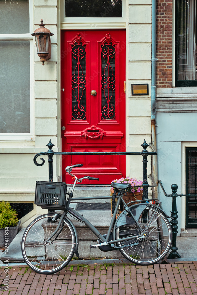 Bicycle near door of old house in Amsterdam street