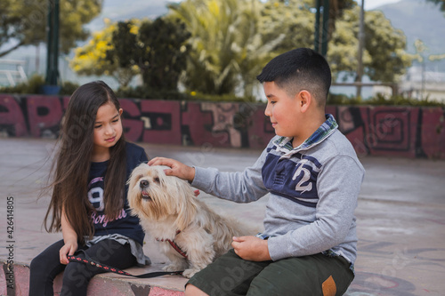 Children friends walking with their pet.