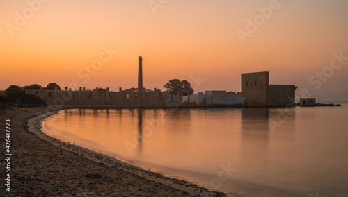 Dawn light on the ruins of the old factory for the processing of tuna and of the medieval watch tower at Vendicari, Syracuse, Sicily, Italy.