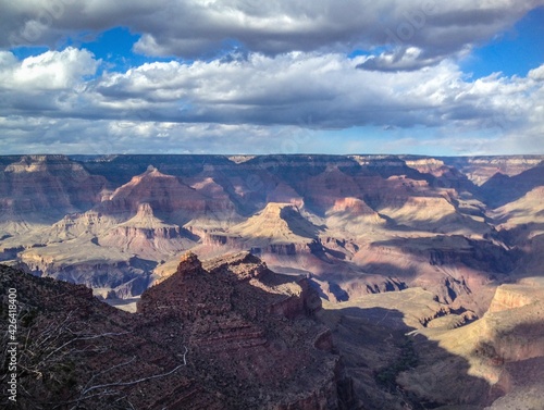 Puffy white clouds in the Grand canyon valley, fantastic view, canyon background