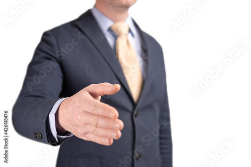 businessman shaking hands, partnership invitation. business people and office concept - businessman with open hand ready for handshake. welcoming new employee at work