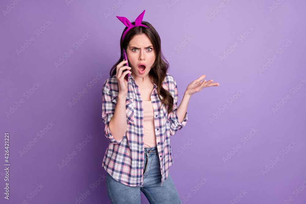 Photo portrait of angry nervous female influencer arguing talking on cellphone furious isolated on vivid violet color background Photo portrait of angry nervous female influencer arguing talking on cellphone furious isolated on vivid violet color background