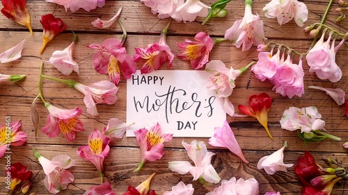 HAPPY MOTHERS DAY card on a wooden table top view 