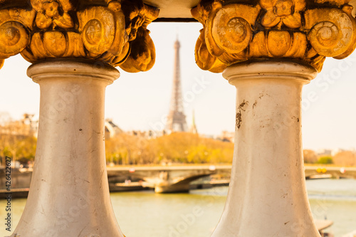 Alexander III bridge on the background unfocused Eiffel tower. Paris, France.
