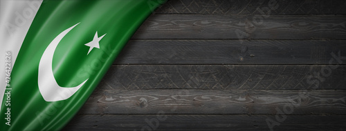 Fotografie Pakistani flag on black wood wall banner