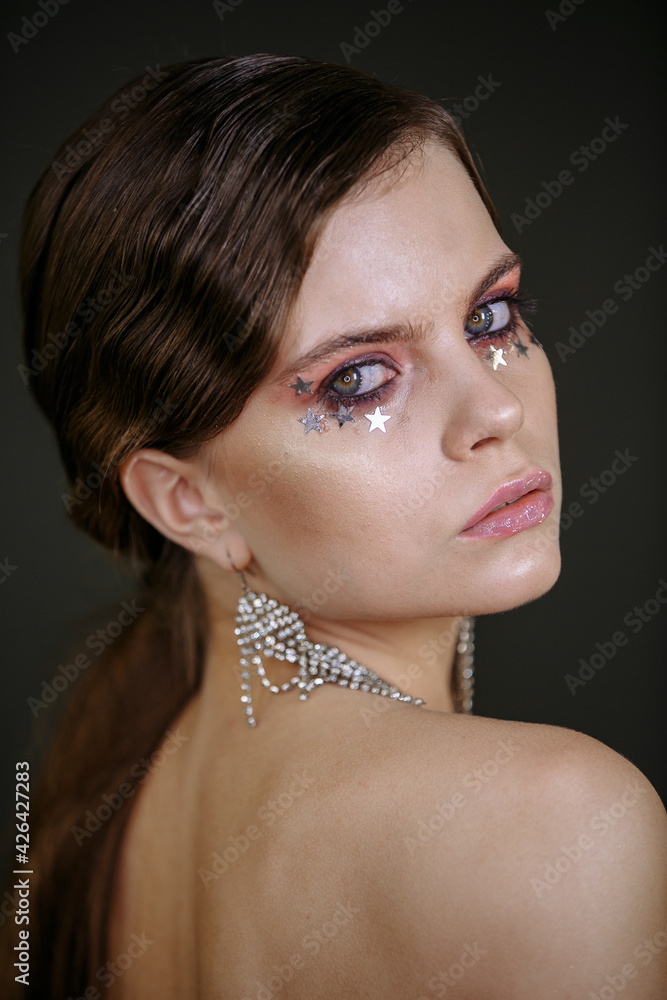 girl with bright makeup and big earrings