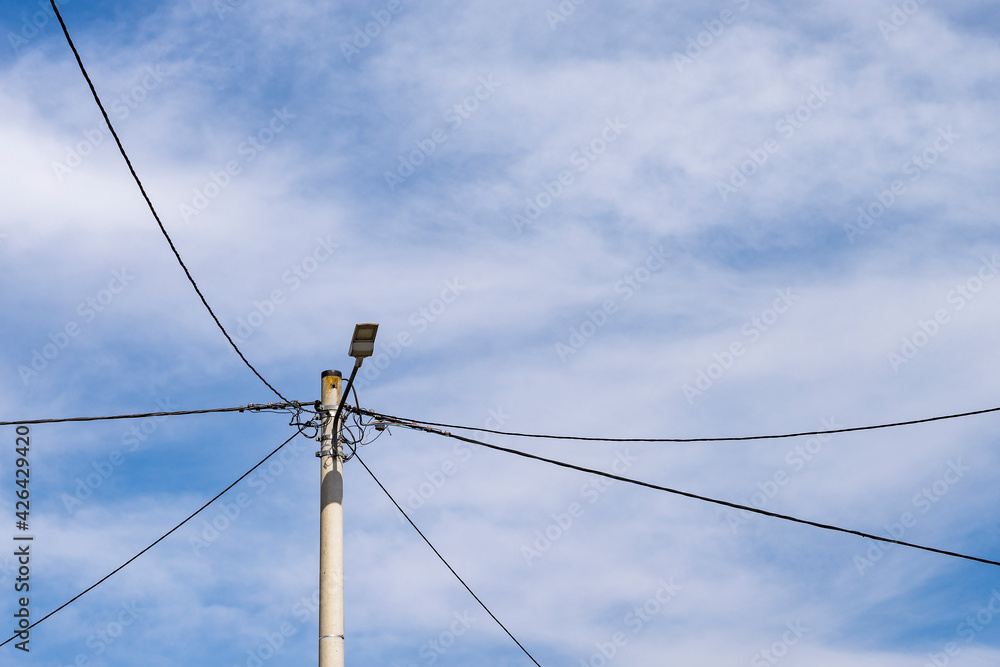 Rural power line against the blue sky. Electricity pole Rural power line against the blue sky. Electricity pole