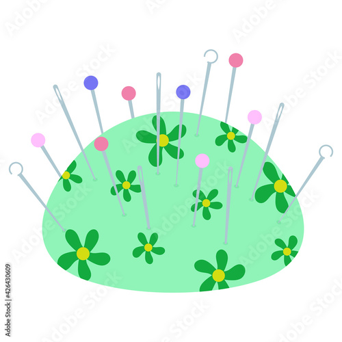 green pincushion with a green pattern of flowers with various needles in it