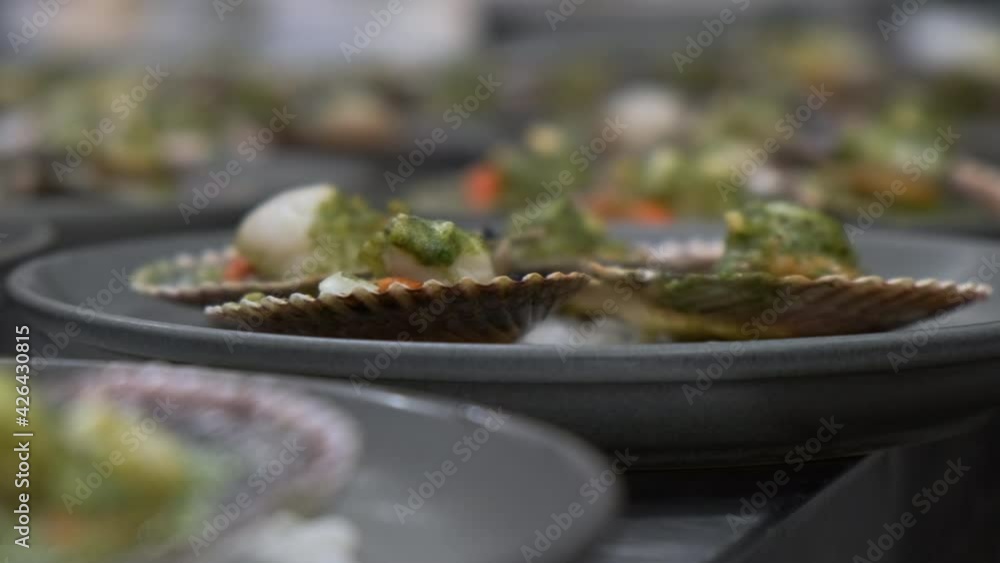 Plates of Scallops Ready for Service in French Fine Dining Restaurant Kitchen Shallow Depth of Field Plates of Scallops Ready for Service in French Fine Dining Restaurant Kitchen Shallow Depth of Field