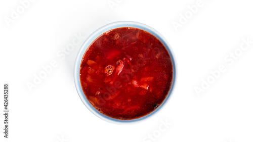 Red, hot borscht - beet soup isolated on a white background.