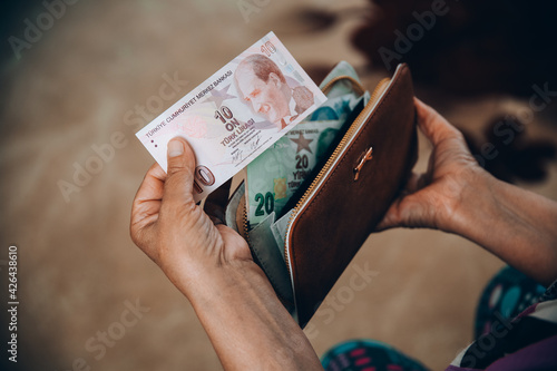 turkish lira in woman's hand photo