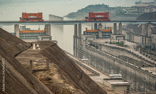 Three Gorges Dam, China - May 6, 2010: Yangtze River. Upper part and entry point into ship lift with heavy red lock door movers on top of rail under foggy morning sky. photo
