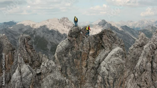 Two climbers climbing on a  dangerous mountain ridge  in the Austrian alps