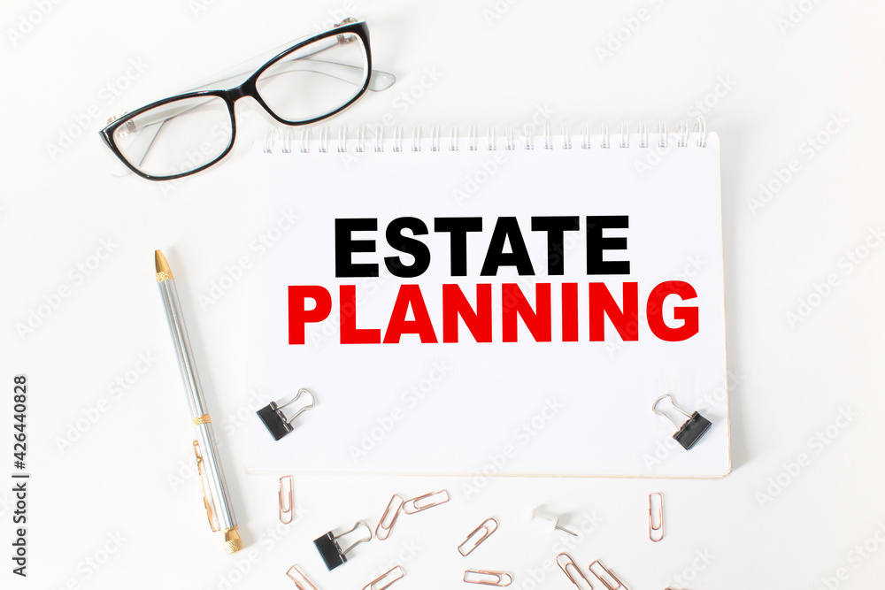 Notepad with inscriptions ESTATE PLANNING on a white background. business concept. Notepad with inscriptions ESTATE PLANNING on a white background. business concept.