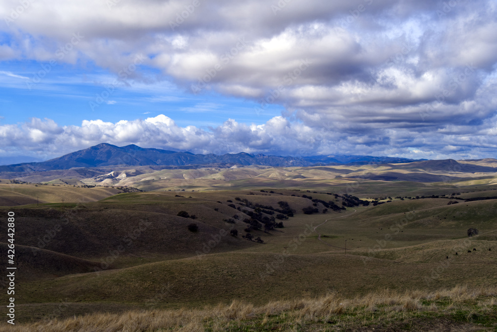 Clouds drifting over the countryside by California Highway 25
