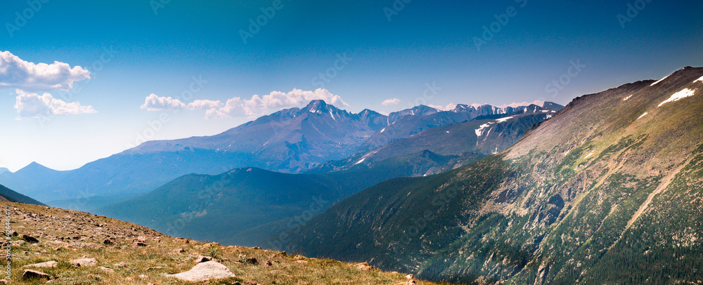 Fototapeta premium Trail Ridge Road in Rocky Mountain National Park during summer showing snow covered peaks on a sunny afternoon