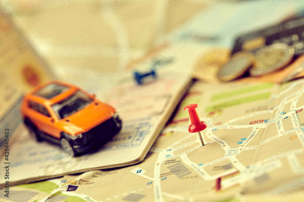 travel concept - small toy car on the map travel concept - small toy car on the map