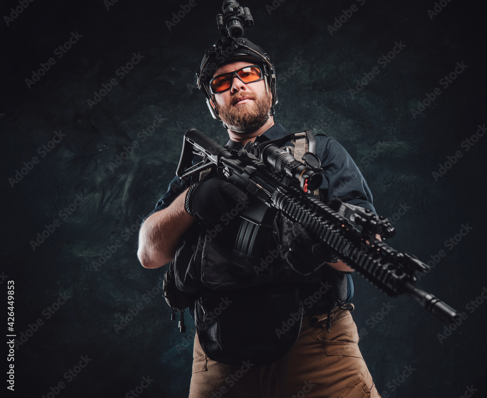Proud special forces soldier dressed in his uniform and holding a rifle Proud special forces soldier dressed in his uniform and holding a rifle