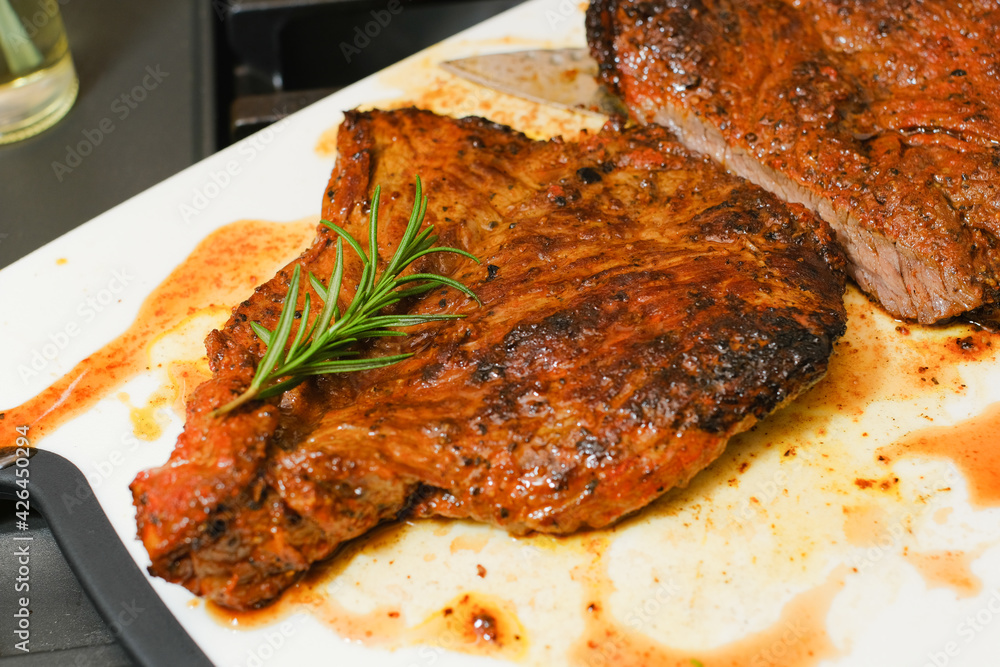 Marinated steak sliced in pieces with cilantro in a cutting board Marinated steak sliced in pieces with cilantro in a cutting board