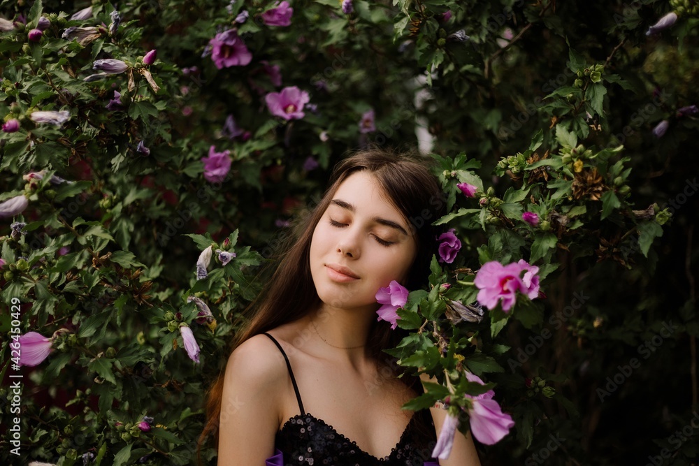 beautiful young girl and pink flowering tree beautiful young girl and pink flowering tree