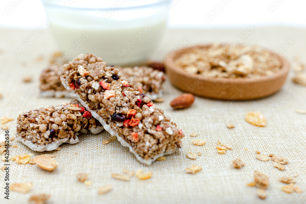 Granola Healthy Snack Bars Granola cereal bar with nuts and berries with yogurt on Sackcloth background Granola Healthy Snack Bars Granola cereal bar with nuts and berries with yogurt on Sackcloth background