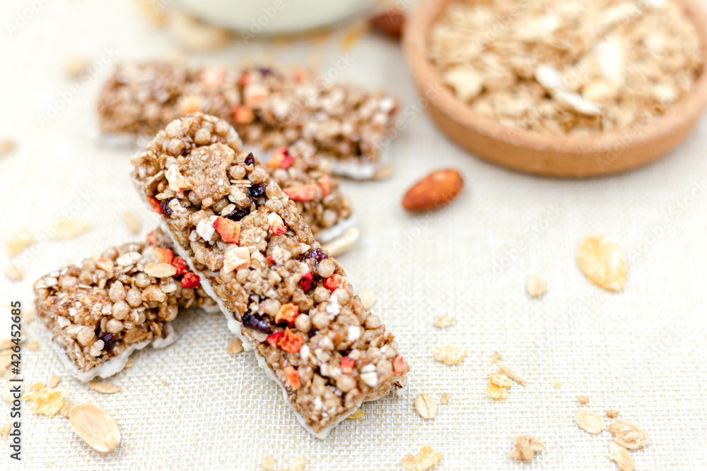 Granola Healthy Snack Bars Granola cereal bar with nuts and berries with yogurt on Sackcloth background Granola Healthy Snack Bars Granola cereal bar with nuts and berries with yogurt on Sackcloth background