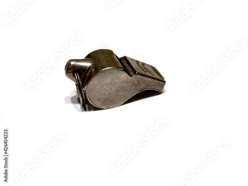 Old Acme Thunderer snail escargot guard whistle. Nickel plated brass. White background. Copyspace photo